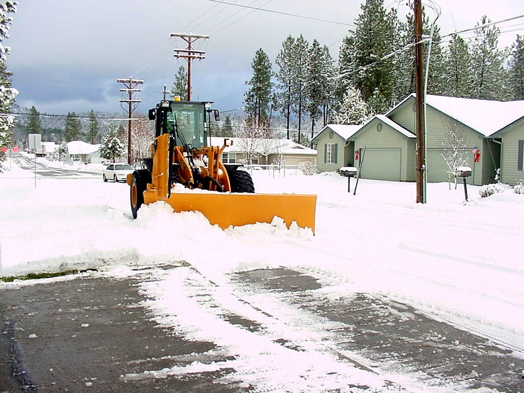 Able Snow Patrol loader plow clearing a street